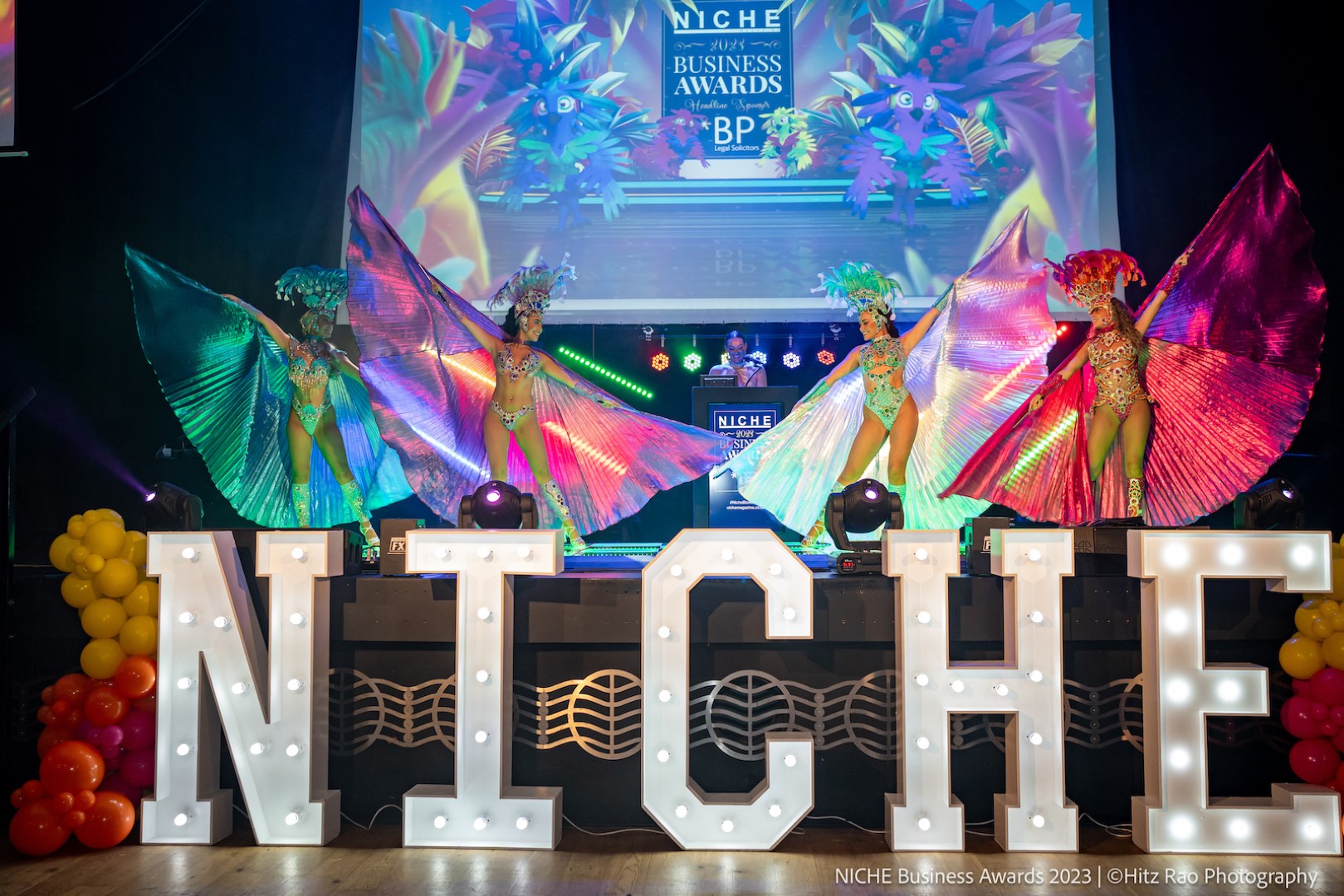 Dancers at the Niche Business Awards dancing above a huge 'NICHE' sign