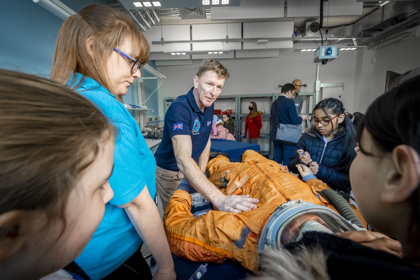 Examining a spacesuit, Tim Peake takes part in Mars Day activity with schoolchildren at the opening of Space Park Leicester